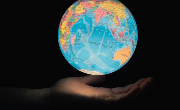 Photo of glowing globe above an open hand